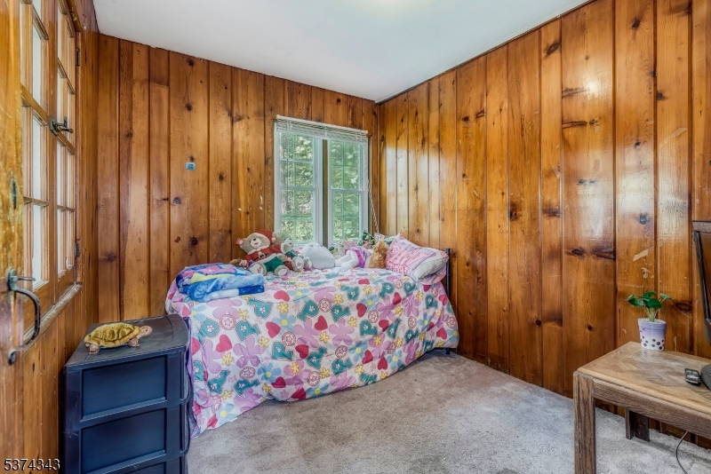 114 Pocantecs Road Vernon, NJ 07422 - Photo 13 of 20 a bedroom with a bed and a table