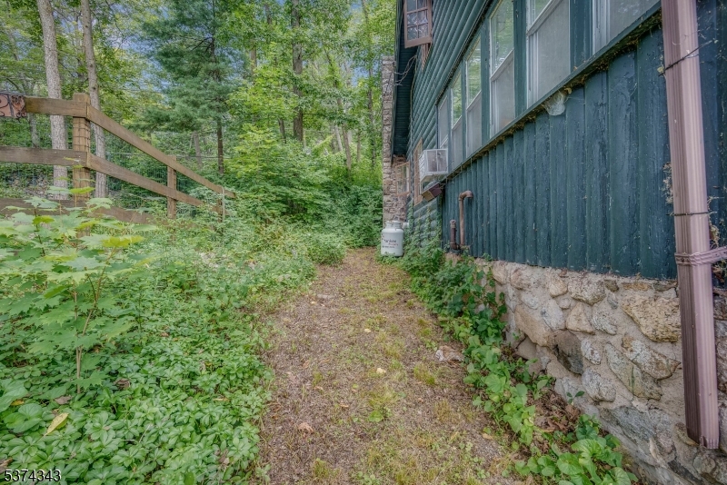 114 Pocantecs Road Vernon, NJ 07422 - Photo 20 of 20 a backyard of a house with lots of green space and trees all around