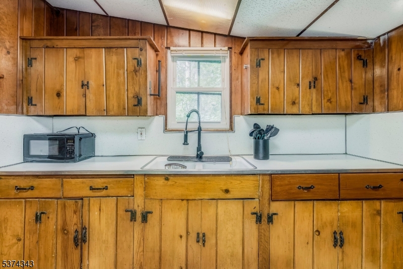 114 Pocantecs Road Vernon, NJ 07422 - Photo 10 of 20 a kitchen with a window a sink and cabinets