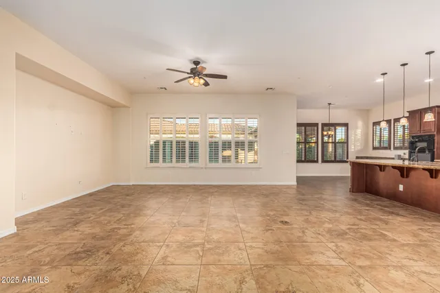 a view of an empty room with a fireplace and a window