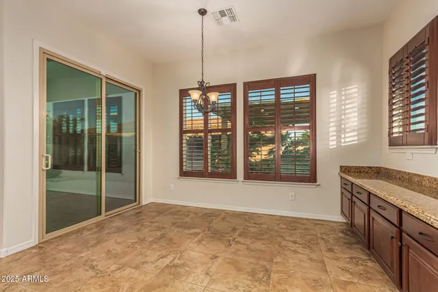 a view of kitchen with stainless steel appliances granite countertop a stove and a refrigerator