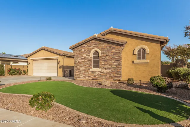 a front view of a house with a garden