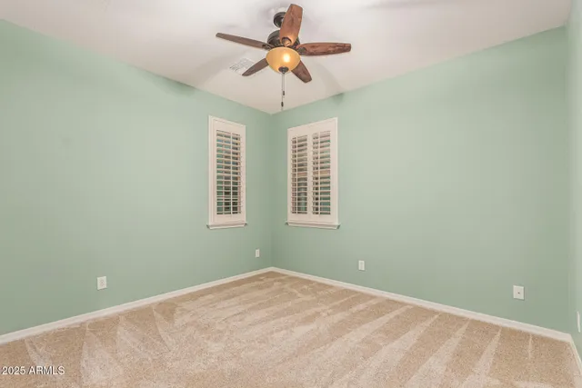 a view of an empty room with a fan