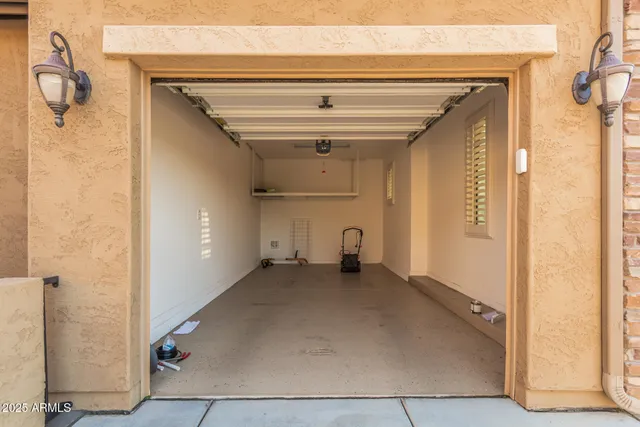 a view of a hallway with wooden floor and a bathroom