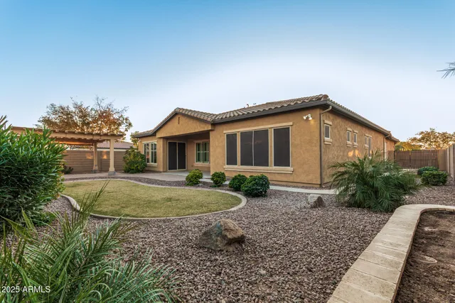 a view of a house with a backyard