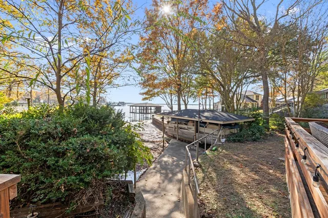 a view of a backyard with table and chairs and a fire pit