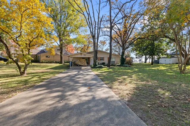a view of a yard with a house and large trees