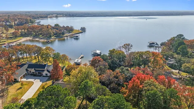 an aerial view of a house with a lake view