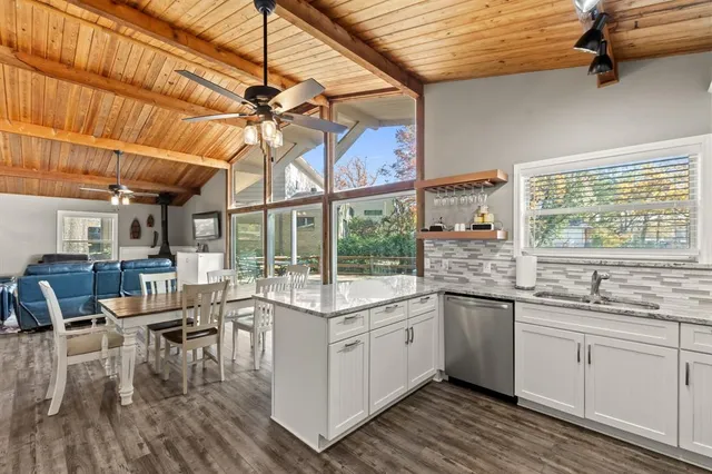 a kitchen with stainless steel appliances granite countertop a sink and cabinets
