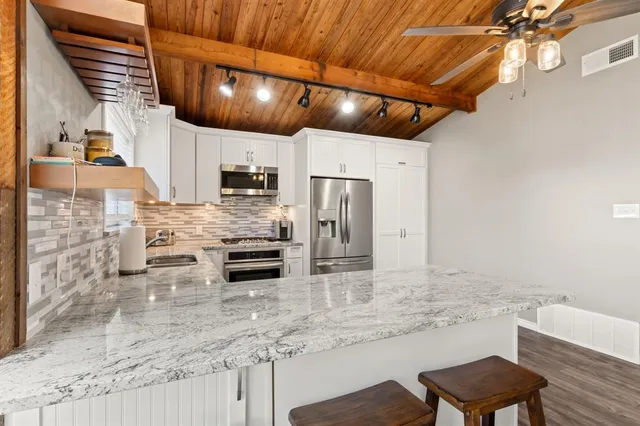 a kitchen with a sink cabinets and refrigerator