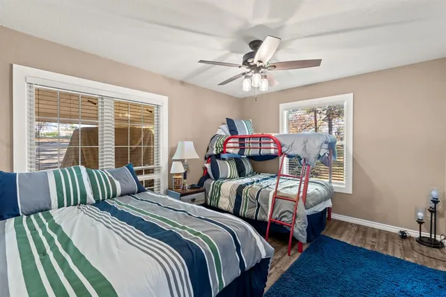 a bedroom with two beds and a large window