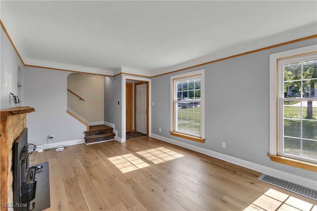 15388 Ridge Road North Royalton, OH 44133 - Photo 7 of 45 Unfurnished living room featuring stairs and light wood-style flooring