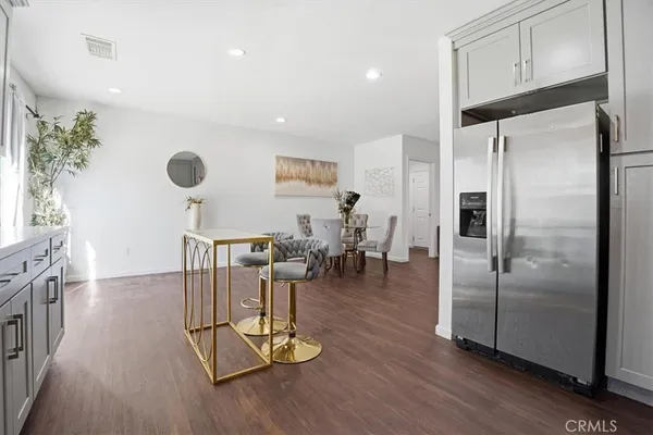 a view of a kitchen with dining table and appliances