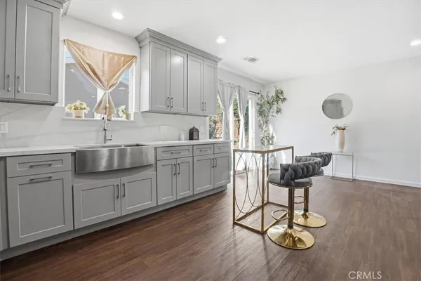 a kitchen with sink cabinets and wooden floor