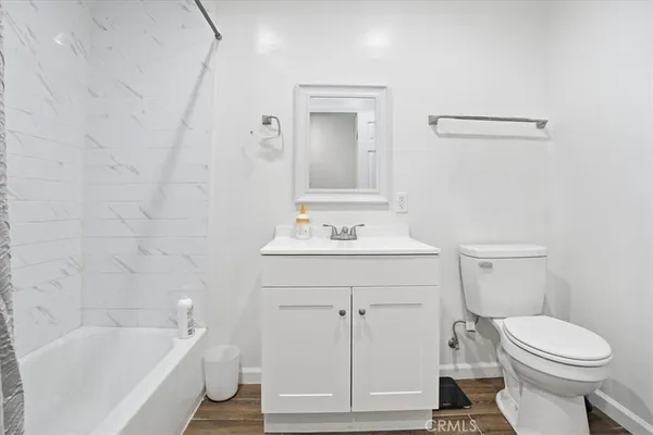 a bathroom with a sink a toilet and bathtub