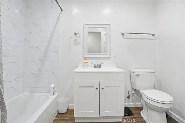 a bathroom with a sink a toilet and bathtub