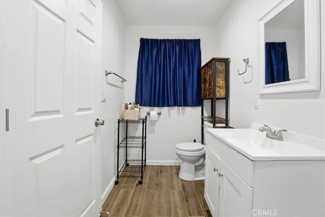 a bathroom with a sink a toilet and a mirror