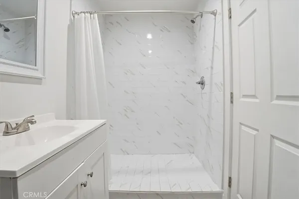 a bathroom with a shower and a sink
