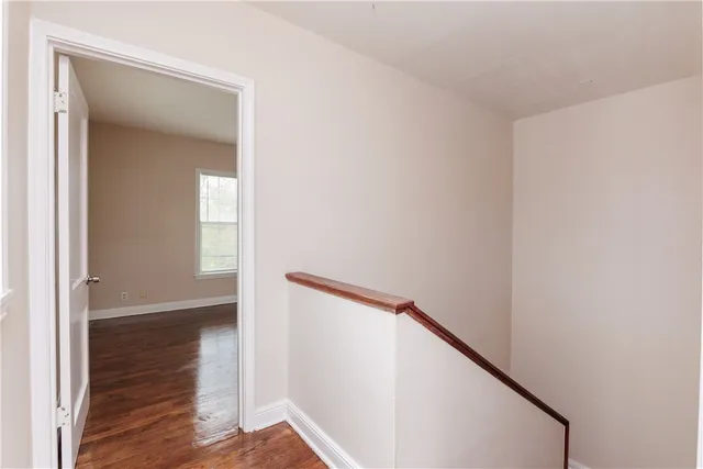 a view of hallway with wooden floor