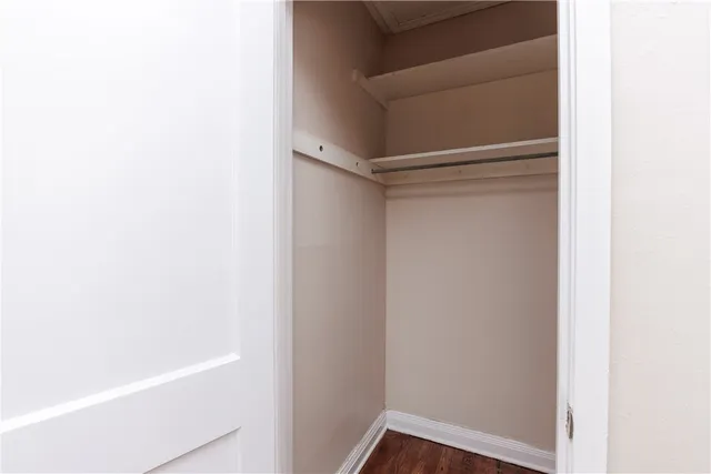 a view of walk in closet with empty racks