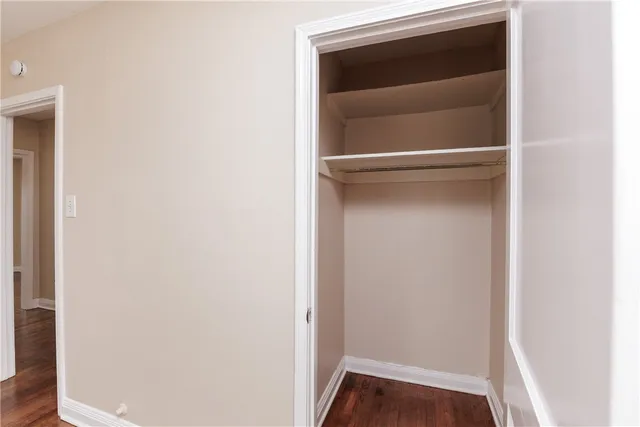 a view of walk in closet with wooden floor