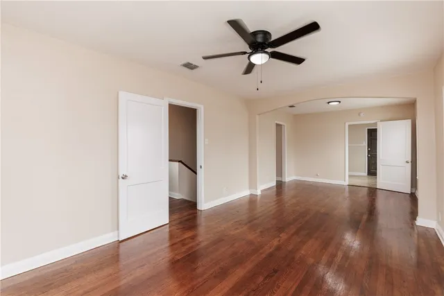 a view of a livingroom with a ceiling fan and wooden floor