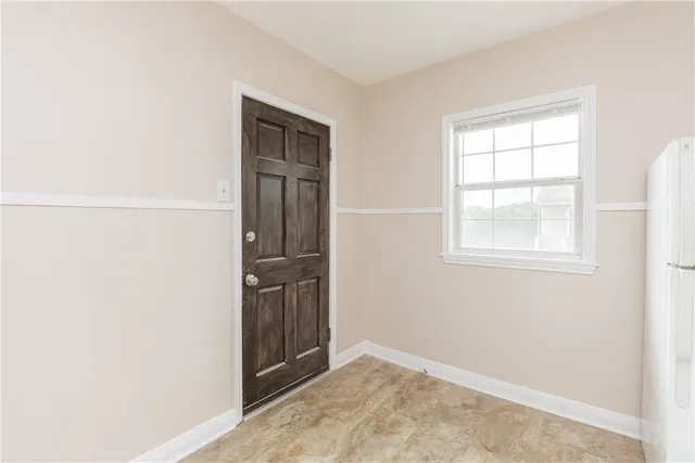 an empty room with windows and closet