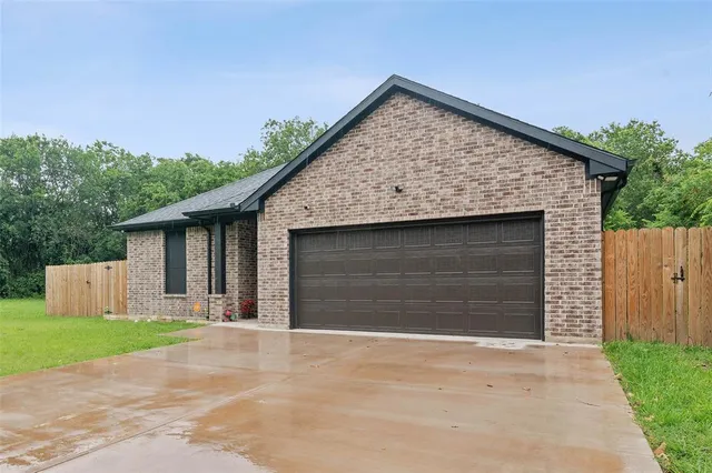 a view of backyard of house with garage