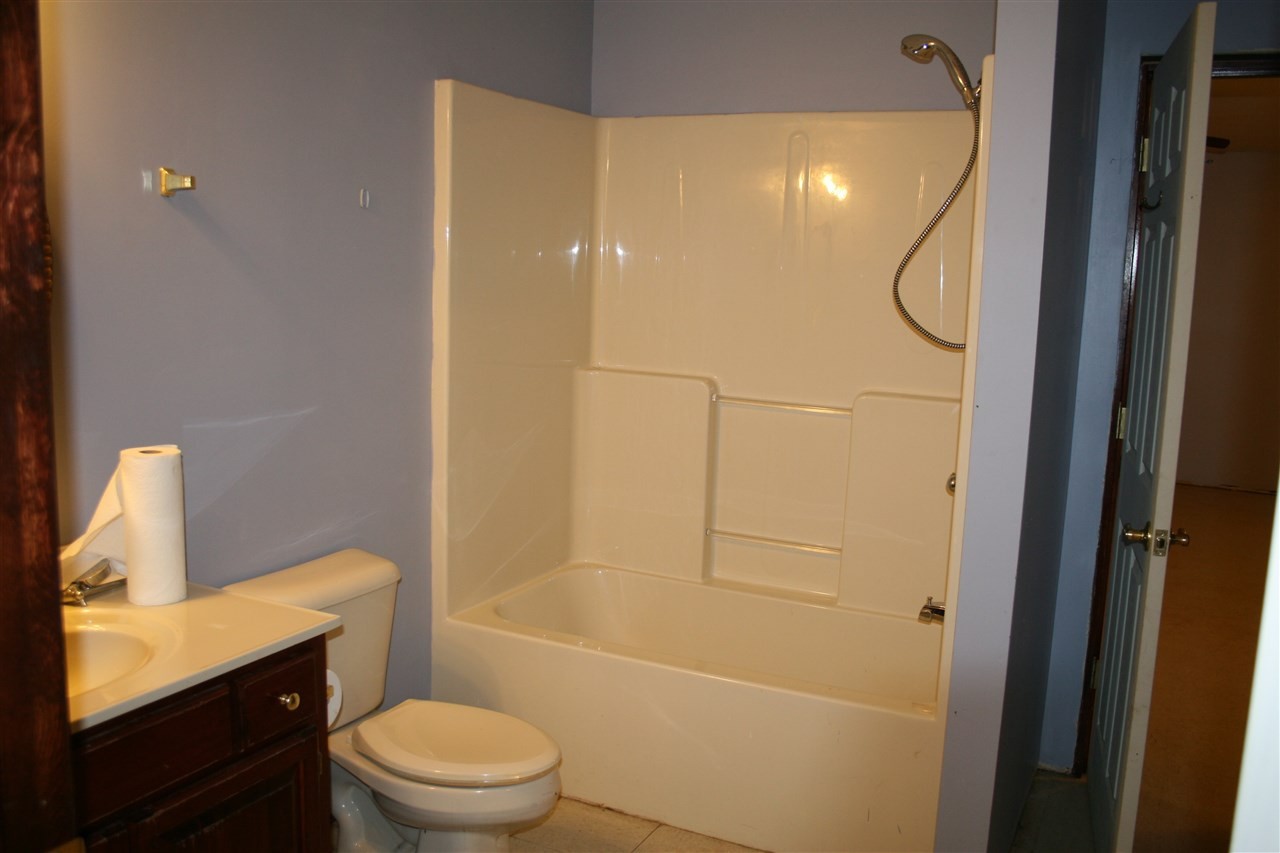 400 Dean Drive Northwest Georgetown, TN 37336 - Photo 12 of 38 a bathroom with a granite countertop sink toilet and shower
