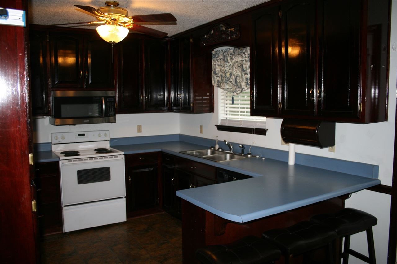 400 Dean Drive Northwest Georgetown, TN 37336 - Photo 7 of 38 a kitchen with a table chairs and a stove