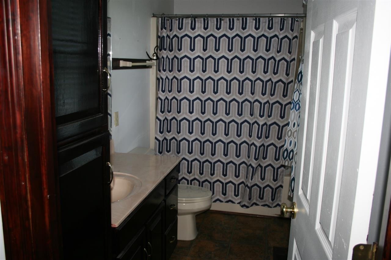 400 Dean Drive Northwest Georgetown, TN 37336 - Photo 10 of 38 a bathroom with a toilet and a shower curtain