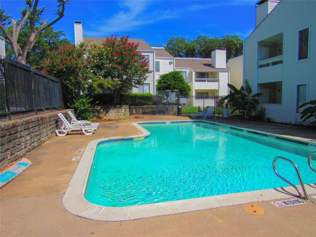 7431 Holly Hill Drive, Unit 216 Dallas, TX 75231 - Photo 1 of 19 a view of a swimming pool with a patio
