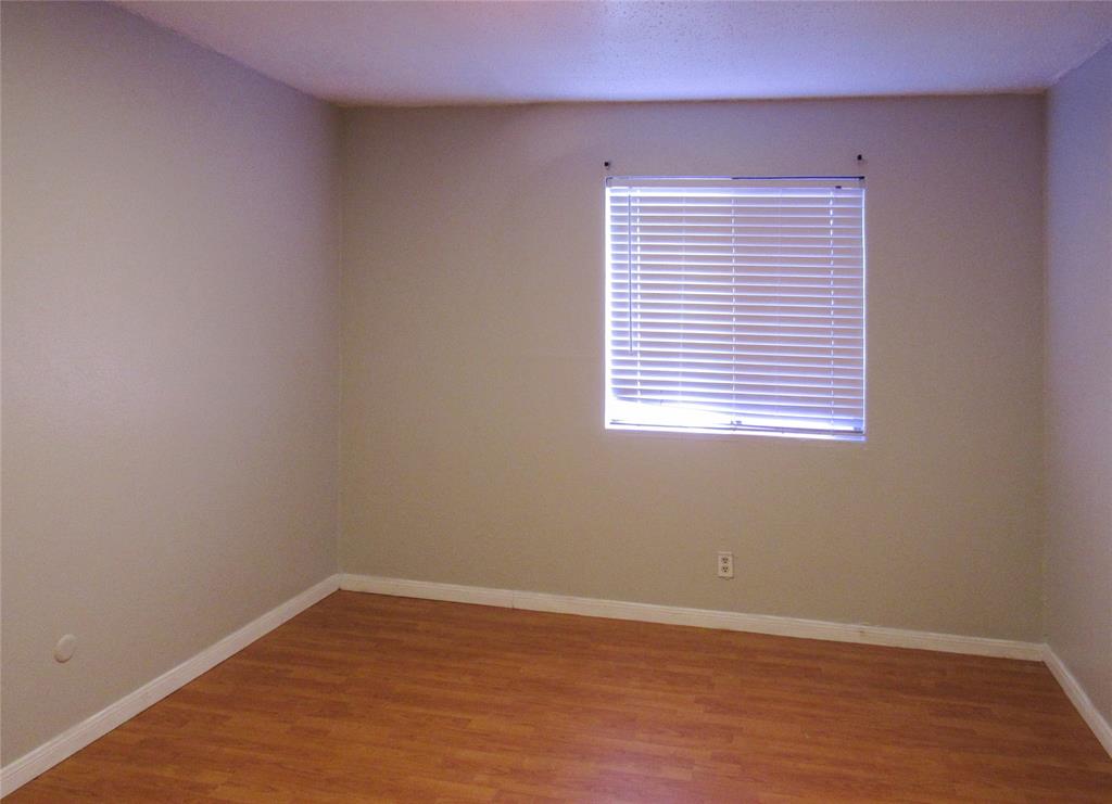 7431 Holly Hill Drive, Unit 216 Dallas, TX 75231 - Photo 11 of 19 an empty room with a window