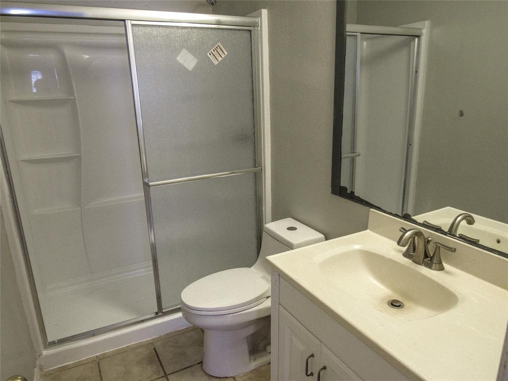 7431 Holly Hill Drive, Unit 216 Dallas, TX 75231 - Photo 12 of 19 a bathroom with a sink toilet and shower