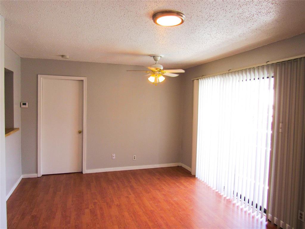 7431 Holly Hill Drive, Unit 216 Dallas, TX 75231 - Photo 6 of 19 a view of an empty room and window
