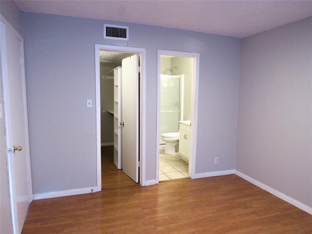7431 Holly Hill Drive, Unit 216 Dallas, TX 75231 - Photo 10 of 19 a view of an empty room and a bathroom