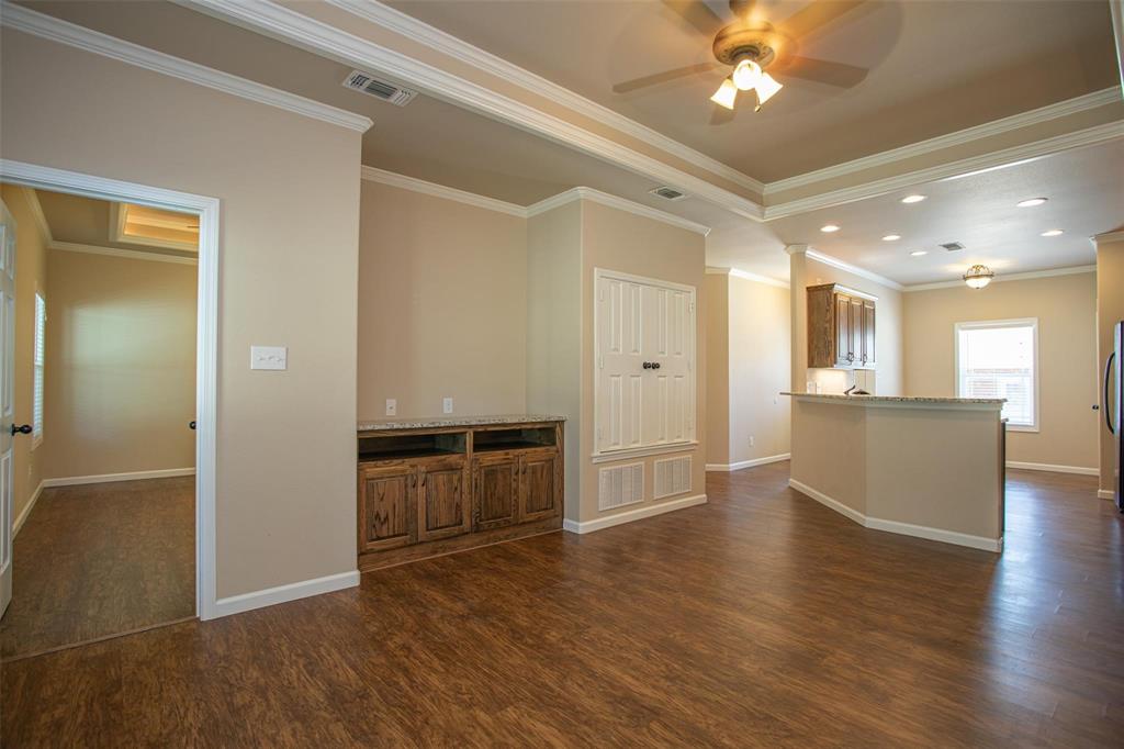 455 Neals Hill Road Oak Ridge, TX 76240 - Photo 8 of 19 Unfurnished living room with crown molding, dark wood finished floors, a ceiling fan, and recessed lighting