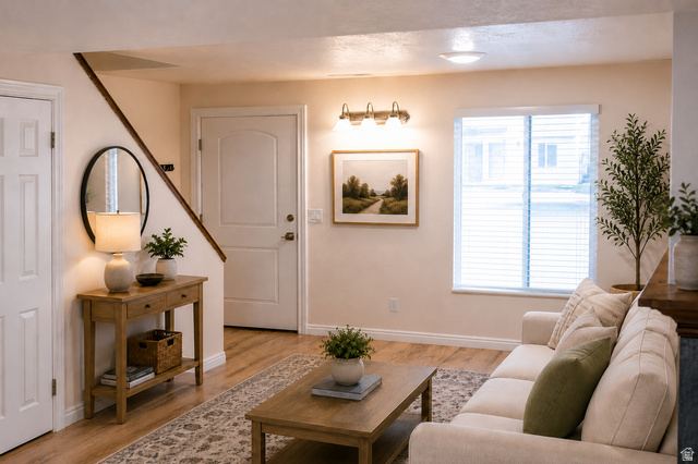 1269 North 400 East, Unit 3 Logan, UT 84341 - Photo 1 of 23 Bright living area featuring wood-finish flooring, a window with blinds, and white interior doors