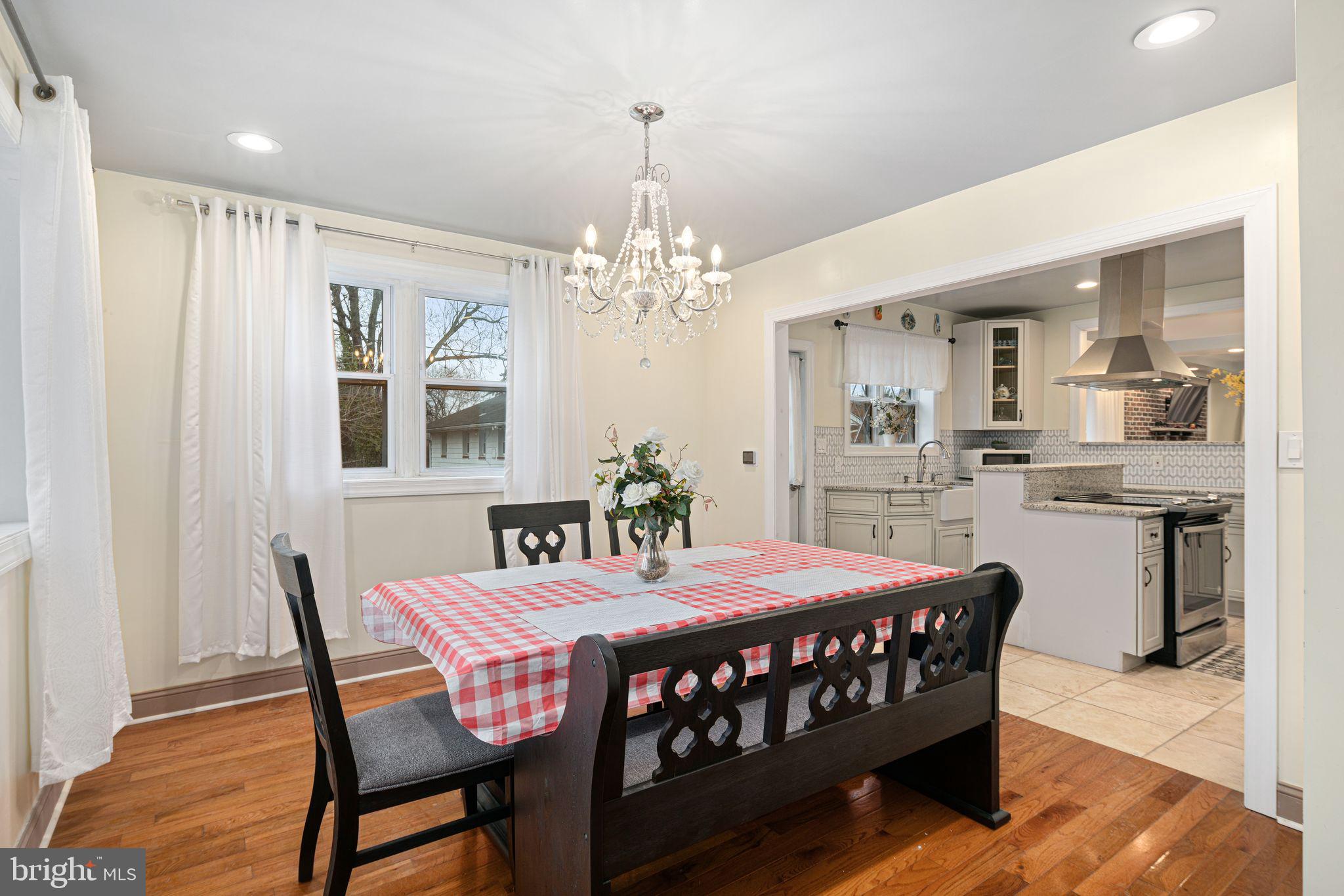 1034 Excelsior Drive Upper Chichester, PA 19014 - Photo 11 of 33 a dining room with furniture a chandelier and wooden floor