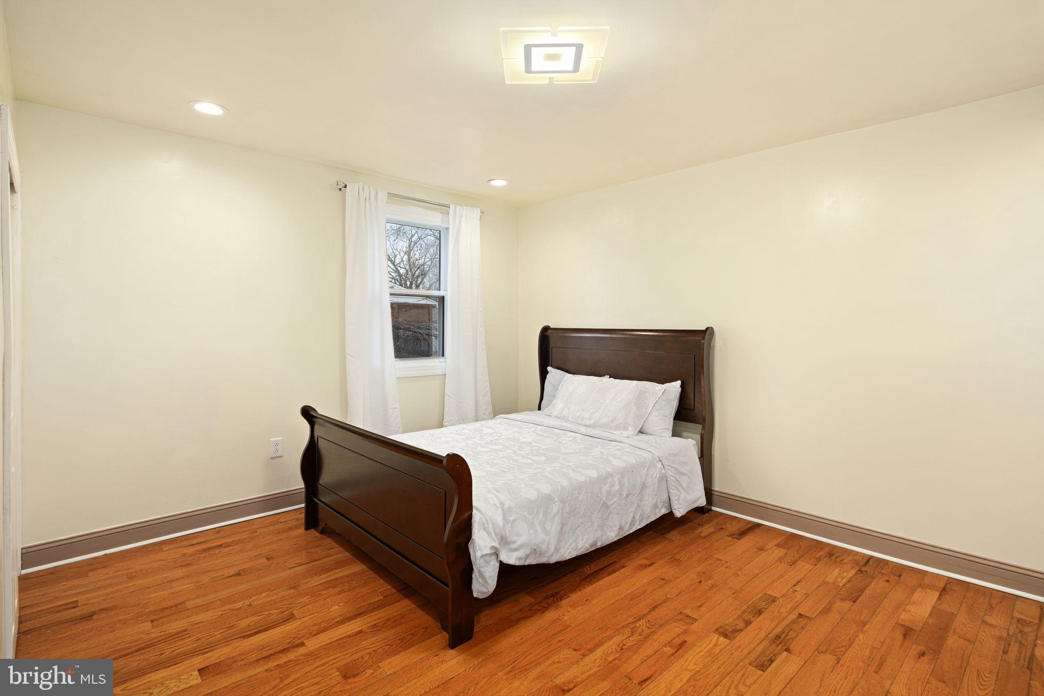 1034 Excelsior Drive Upper Chichester, PA 19014 - Photo 15 of 33 a bedroom with a bed and wooden floor