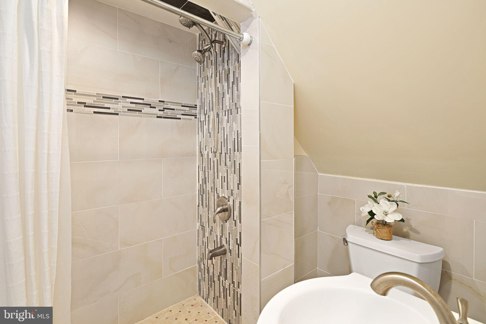 1034 Excelsior Drive Upper Chichester, PA 19014 - Photo 17 of 33 a bathroom with a shower curtain and a toilet