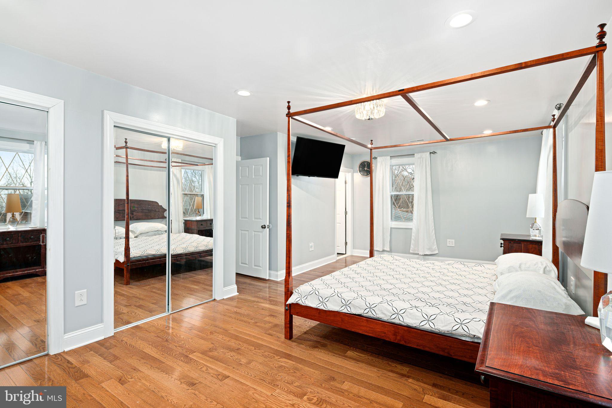 1034 Excelsior Drive Upper Chichester, PA 19014 - Photo 22 of 33 a bedroom with a bed and a walk in closet with wooden floor