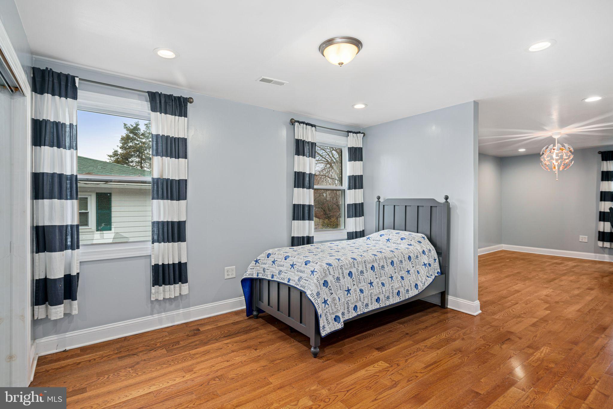 1034 Excelsior Drive Upper Chichester, PA 19014 - Photo 24 of 33 a bedroom with a large bed wooden floor and window