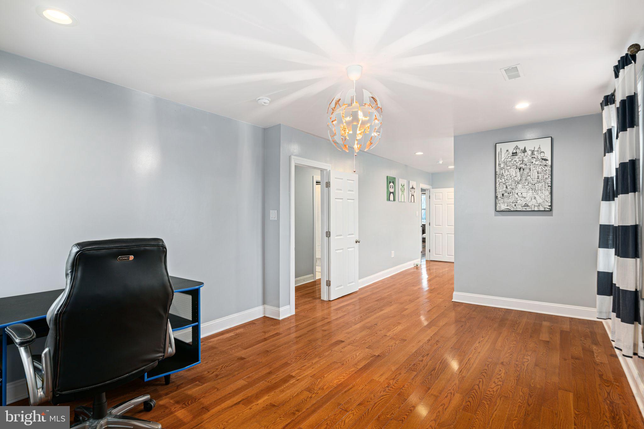 1034 Excelsior Drive Upper Chichester, PA 19014 - Photo 27 of 33 a view of a workspace with furniture and a chandelier