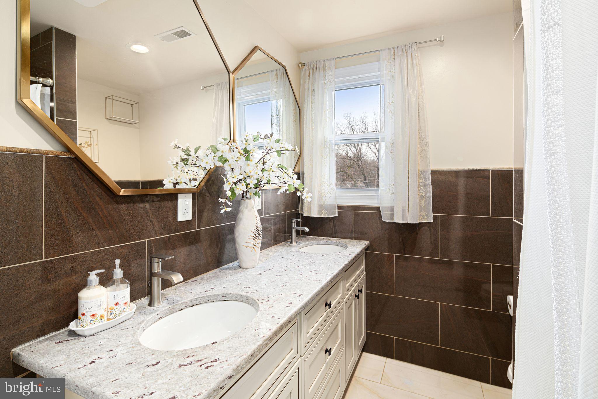 1034 Excelsior Drive Upper Chichester, PA 19014 - Photo 30 of 33 a bathroom with a granite countertop sink a mirror and shower