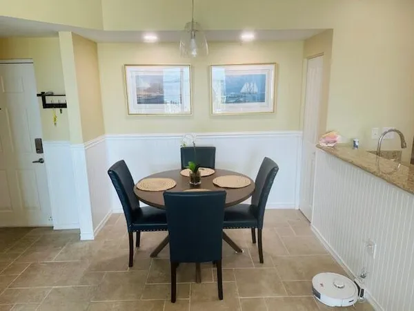 a dining room with wooden floor glass table and chairs