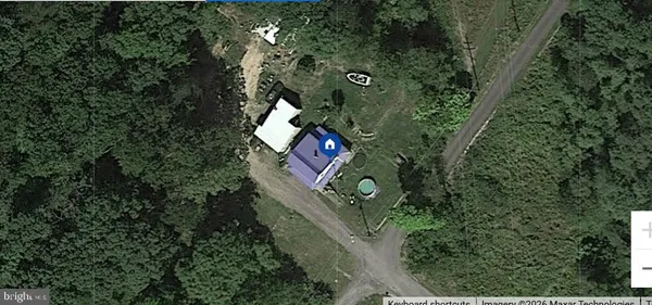 an aerial view of a house with outdoor space