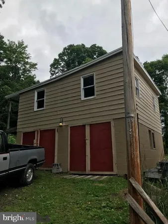 a view of backyard of house with green space