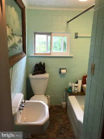 a bathroom with a sink toilet and a mirror