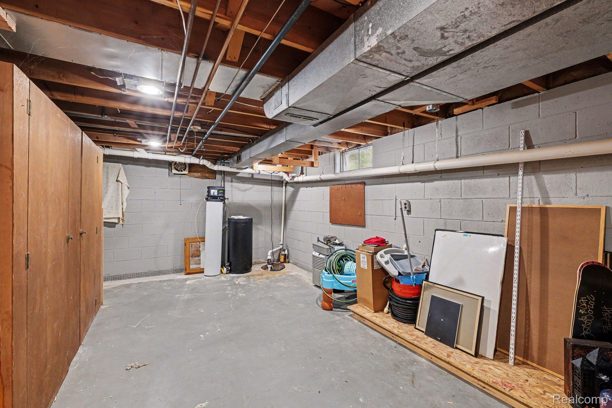 5449 South Genesee Road Grand Blanc, MI 48439 - Photo 15 of 18 Concrete block wall construction with exposed ceiling joists and ductwork